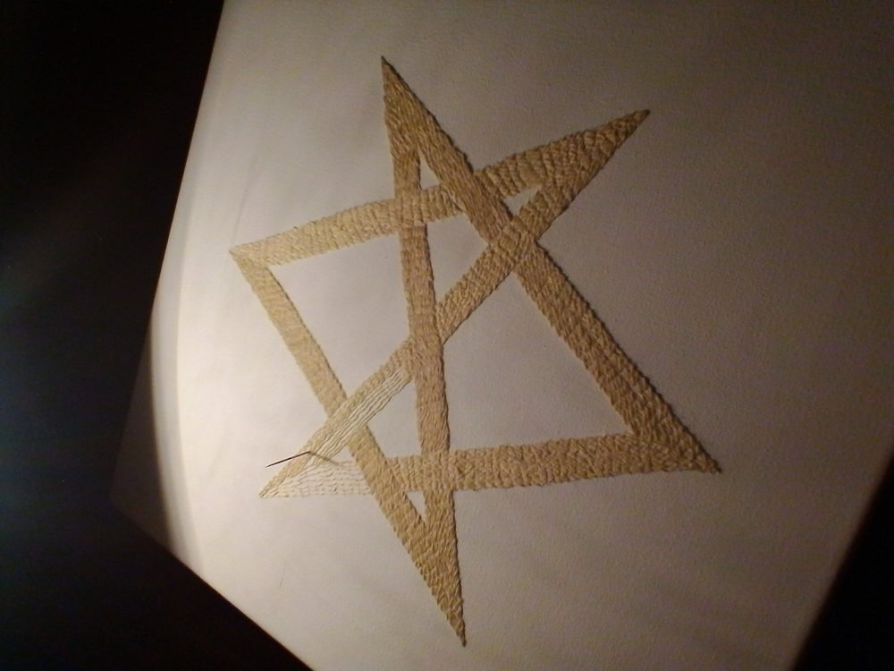 Embroidering the unicursal hexagram.