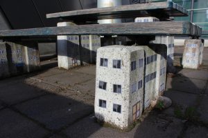 Stickers on outside seating turning it into brutalist housing complex.