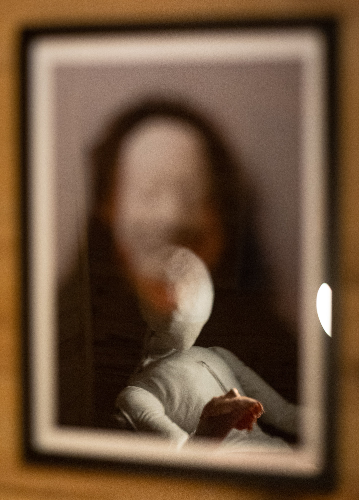 The humanoid figure reflected on the artist's portrait,